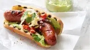 hotdog in bun with avocado