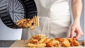 food pouring out of air fryer basket