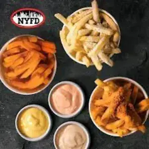 overheada shot of fries and dipping sauces