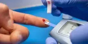 person pricking finger for blood test