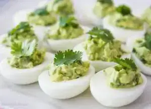 boiled eggs sliced and filled with avocado