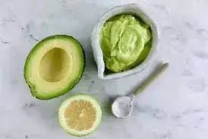 avocado half with lime and dish